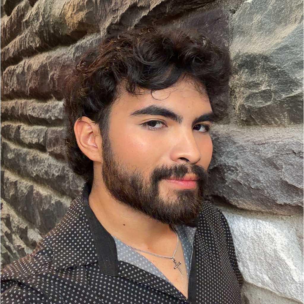 Portrait of Nicholas Cervantes leaning against a stone wall